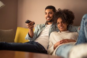 couple watching television at home