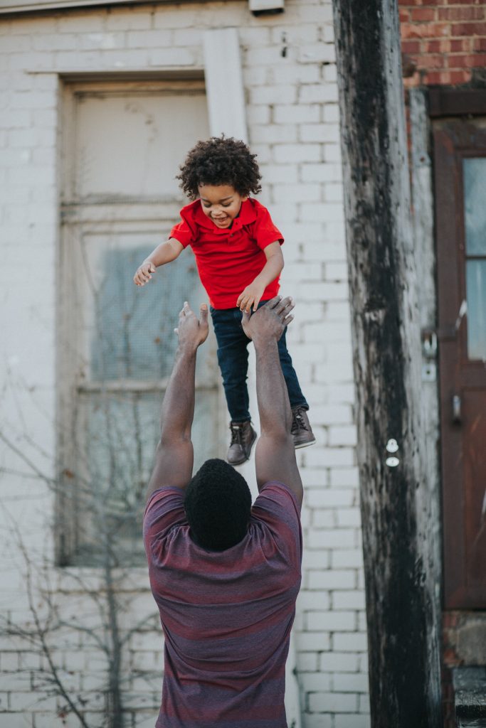 Father tosses son in air 