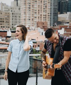 Couple on rooftop playing guitar