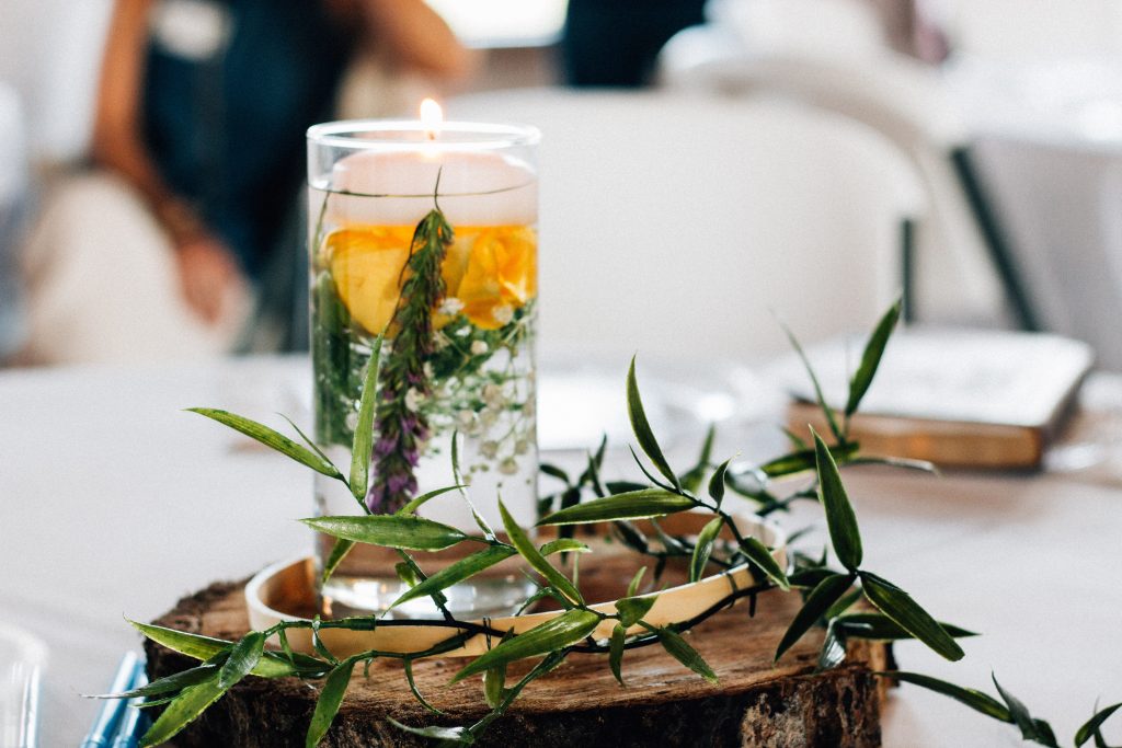 herbs in water with a candle