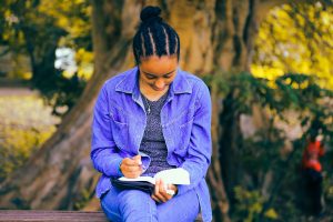 Young woman reading outside in nature