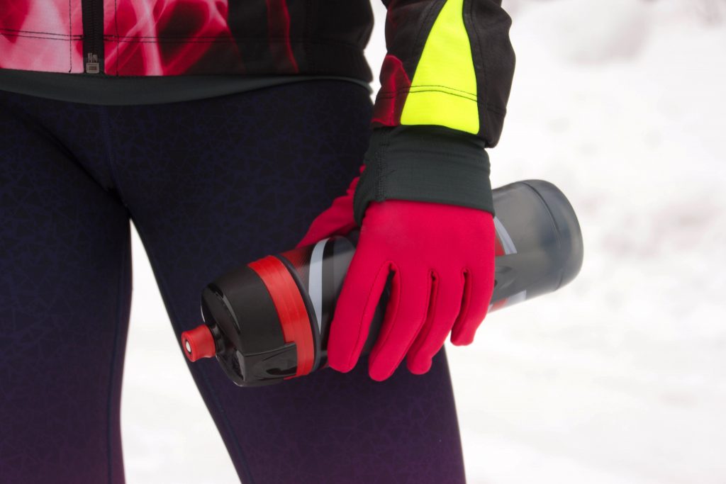 woman wearing gloves and waterbottle