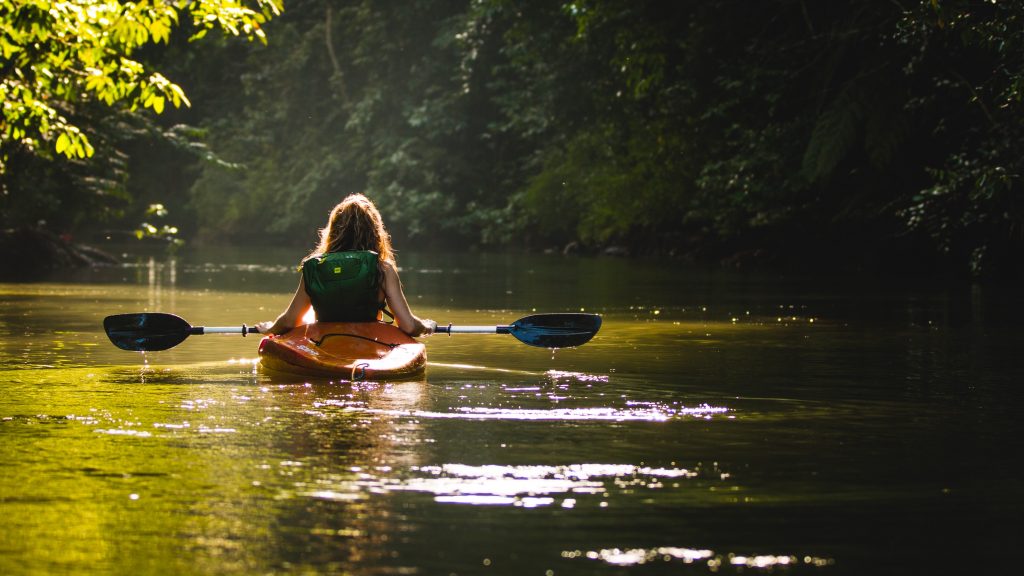 Woman on kayak in a lake